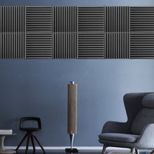Load image into Gallery viewer, a room with a blue wall and a grey chair
